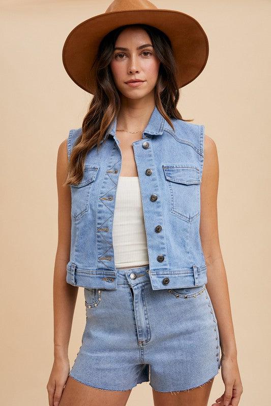 Women wearing a Cowboy hat wearing a denim vest.